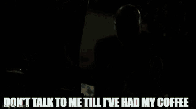 a person standing next to a car with the words " don t talk to me till i 've had my coffee "