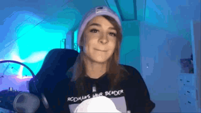 a woman wearing a hat and a t-shirt that says rodman 's lhr bender
