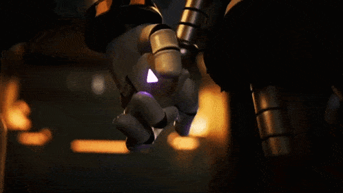a close up of a robotic hand with a triangle on it