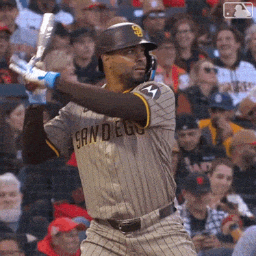 a baseball player for the san diego padres swings at a pitch