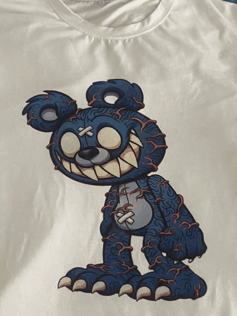 a white t-shirt with a cartoon of a teddy bear on it