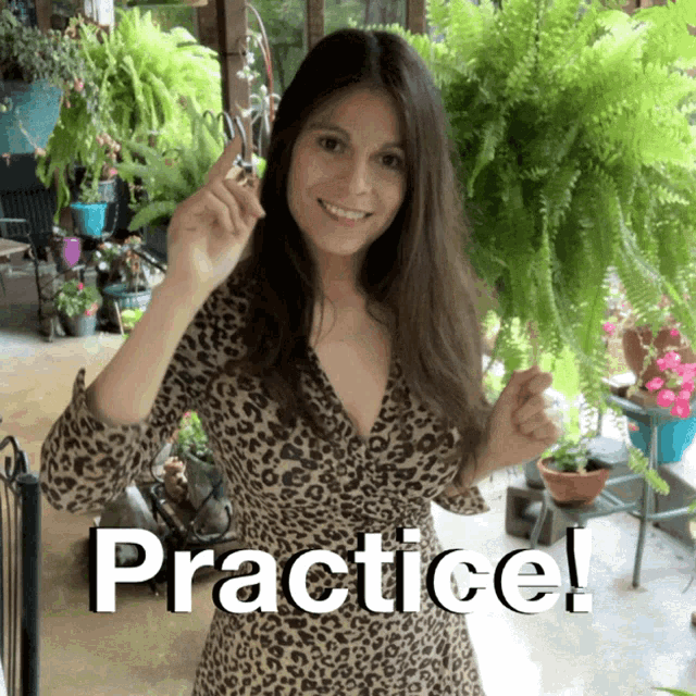 a woman in a leopard print dress is holding a pair of scissors and says practice