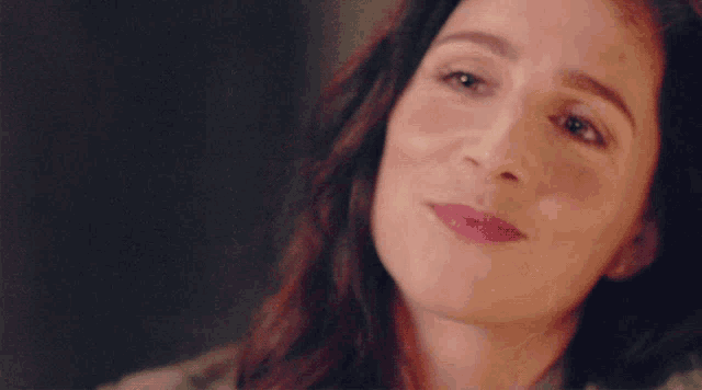 a close up of a woman 's face smiling
