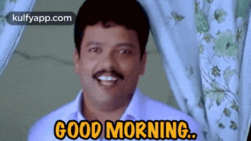 a man with a mustache is smiling and saying `` good morning '' .