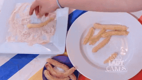 two plates of food on a table with a lady cakes logo on the bottom
