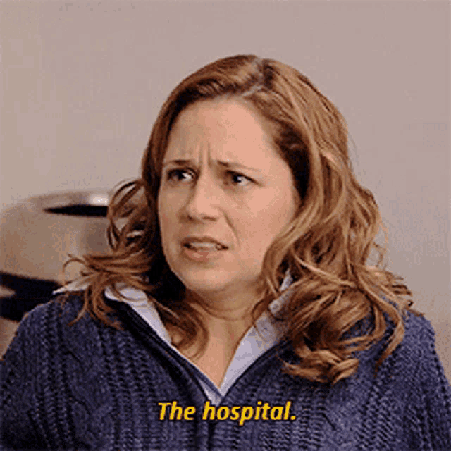 a woman in a blue sweater is talking about the hospital