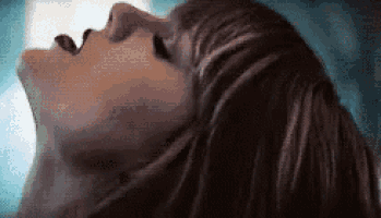 a close up of a woman with her mouth open .
