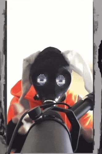 a person wearing a gas mask with smiley faces on them