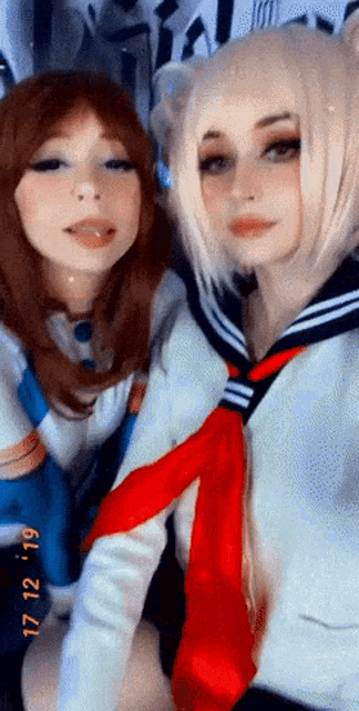 two girls are posing for a photo with the date 17 12 119