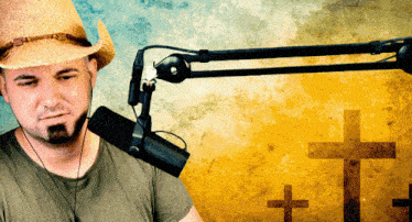 a man wearing a cowboy hat is sitting in front of a microphone