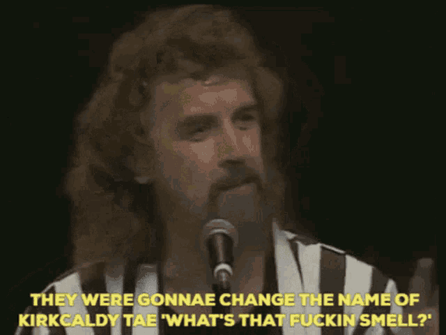 a man speaking into a microphone with the words they were gonnae change the name of kirkcaldy tae