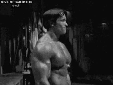 a black and white photo of arnold schwarzenegger in a gym .