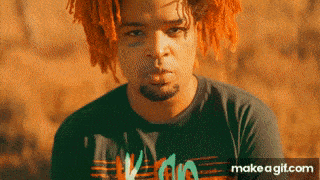 a man with dreadlocks and a beard is wearing a black shirt that says ' i 'm a '