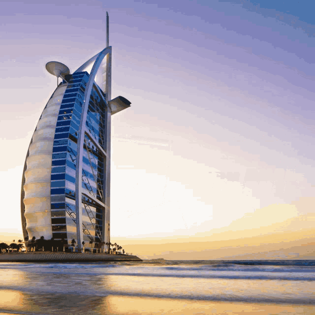 the burj khalifa is a very tall building sitting on top of a beach