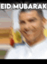a blurry picture of a man with the words `` eid mubarak '' on it .