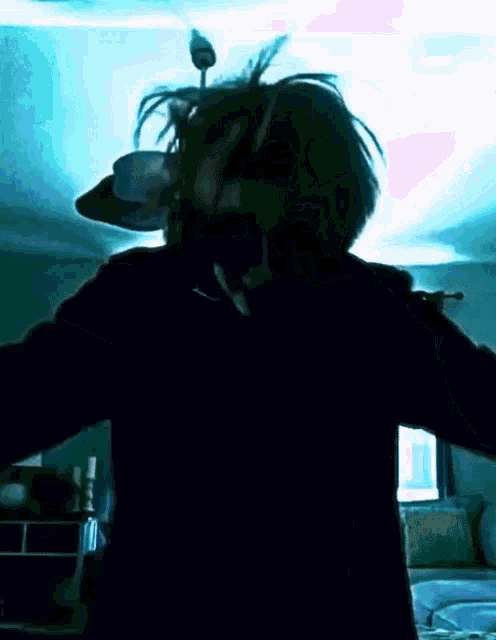 a person wearing sunglasses is standing in a dark room