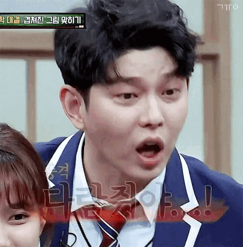 a man in a suit and tie making a funny face