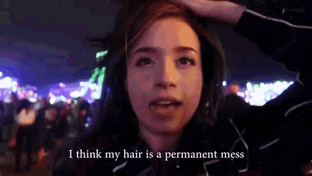 a woman says i think my hair is a permanent mess in front of a crowd of people