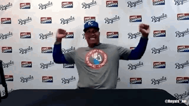 a man is standing in front of a wall that says royals