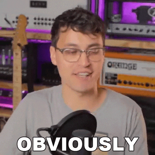 a man wearing glasses is talking into a microphone and says obviously .