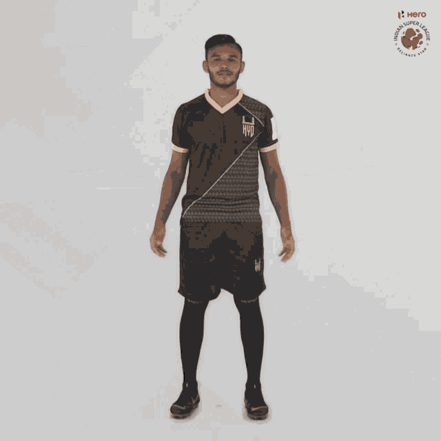a man in a black and gold jersey with the word hero on the bottom