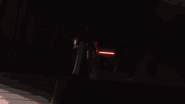 a group of people holding lightsabers in a dark room