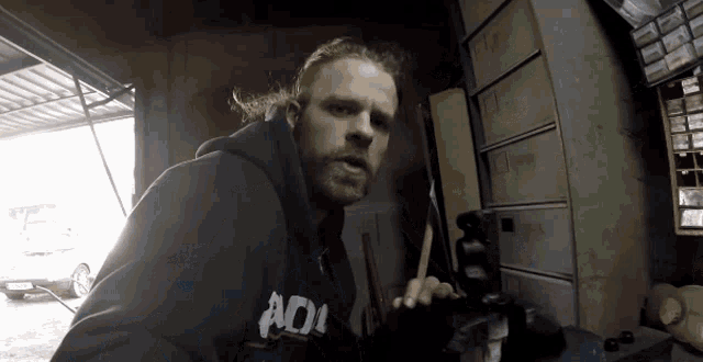 a man wearing a black hoodie that says adi