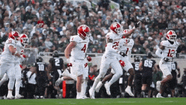a group of football players on a field with one wearing a number 4 jersey