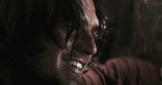 a close up of a man 's face with a bloody nose