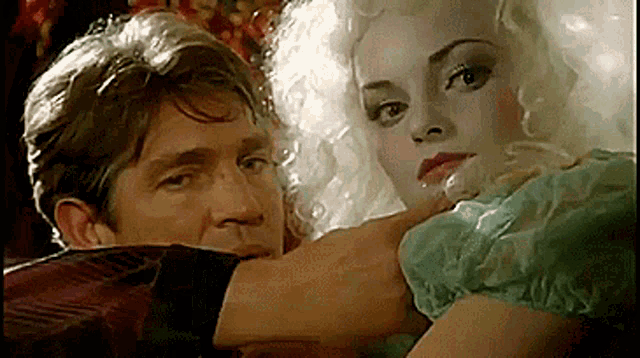 a man and a woman are looking at each other in a movie .