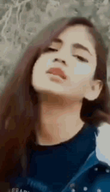a close up of a woman 's face with her eyes closed and her mouth open .
