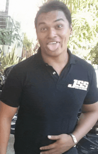 a man wearing a black shirt with the letters j and s on it