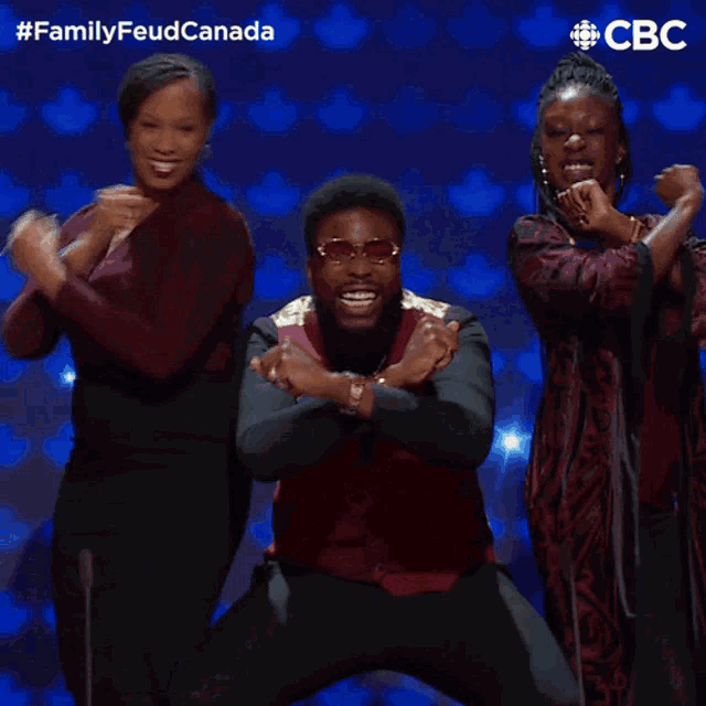 a group of people are dancing in front of a blue background that says cbc on it