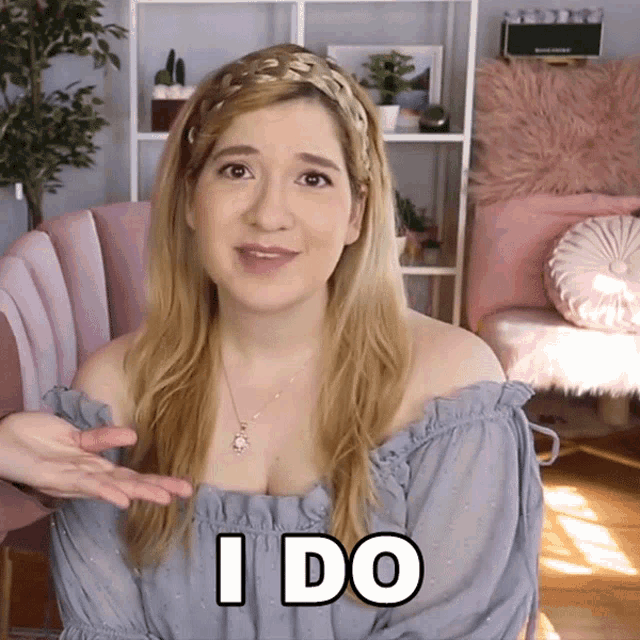 a woman says i do in a room with pink chairs