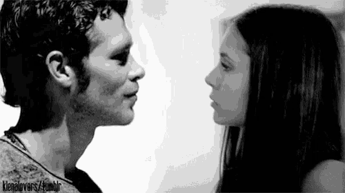 a man and a woman are looking into each other 's eyes .