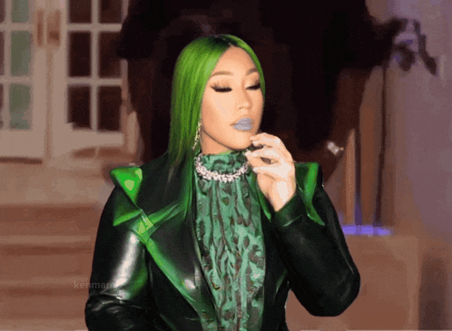 a woman with green hair wearing a green jacket