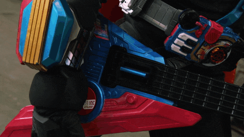 a person is holding a toy guitar with a belt that says ' nn ' on it