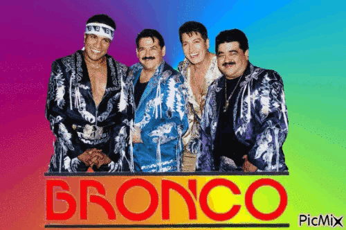 a group of men standing next to each other in front of a sign that says bronco