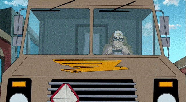 a man wearing glasses is driving a delivery truck with a yellow eagle on the front