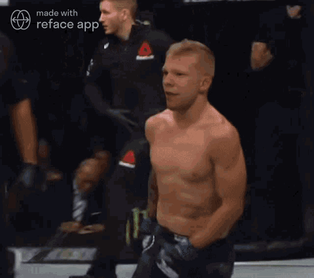 a man without a shirt is in a boxing ring with a monster energy sign behind him