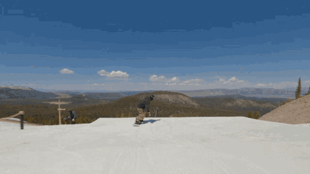 a snowboarder is doing a trick on a snowy slope