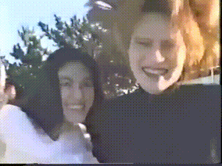 two women are posing for a picture together and smiling