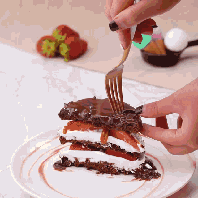 a person holding a fork over a piece of cake