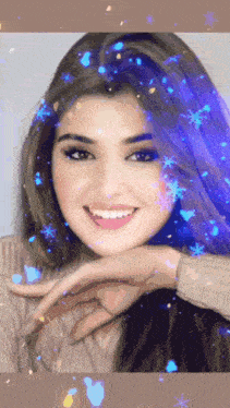 a close up of a woman 's face with snowflakes in her hair
