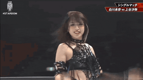 two women are wrestling in a ring with a sign that says stardom