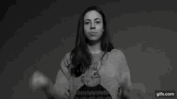 a black and white photo of a woman pointing at the camera with the words se fodeu above her .
