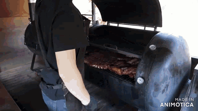 a person is standing in front of a grill that says made in animotica