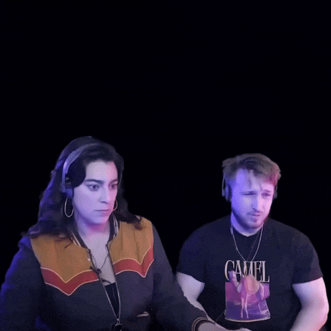 a man wearing a camel t-shirt stands next to a woman