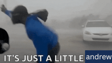 a blurred image of a person and a car with the words it 's just a little andrew