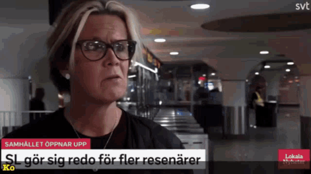 a woman wearing glasses and a necklace is on a svt channel